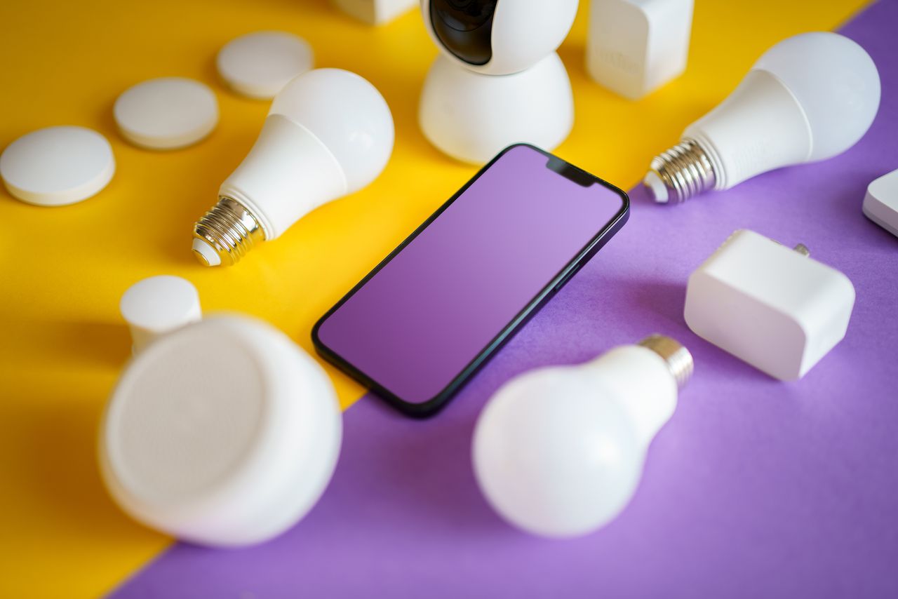 team-02 Colorful flat lay of smart home devices and smartphone on vibrant background, ideal for technology concepts.